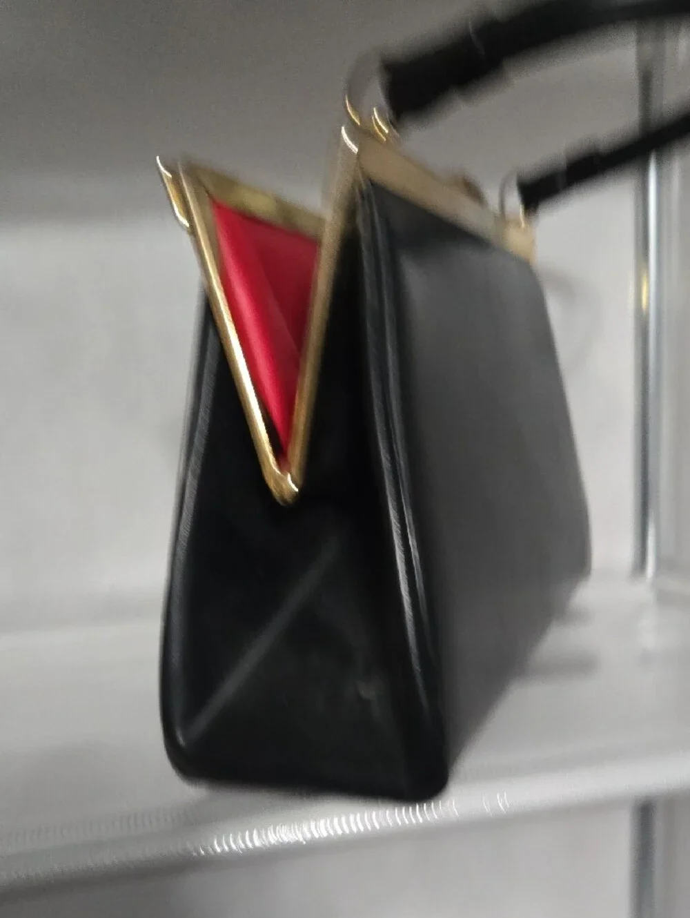 Structured Black Leather Frame Wristlet with Gold Accent
